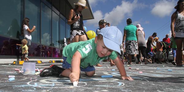3 yr old Noah of Tauranga has fun with chalk at footsteps Kids Day Out 